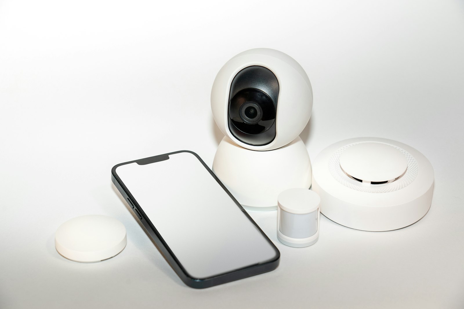 Smartphone next to a security camera receiving alerts